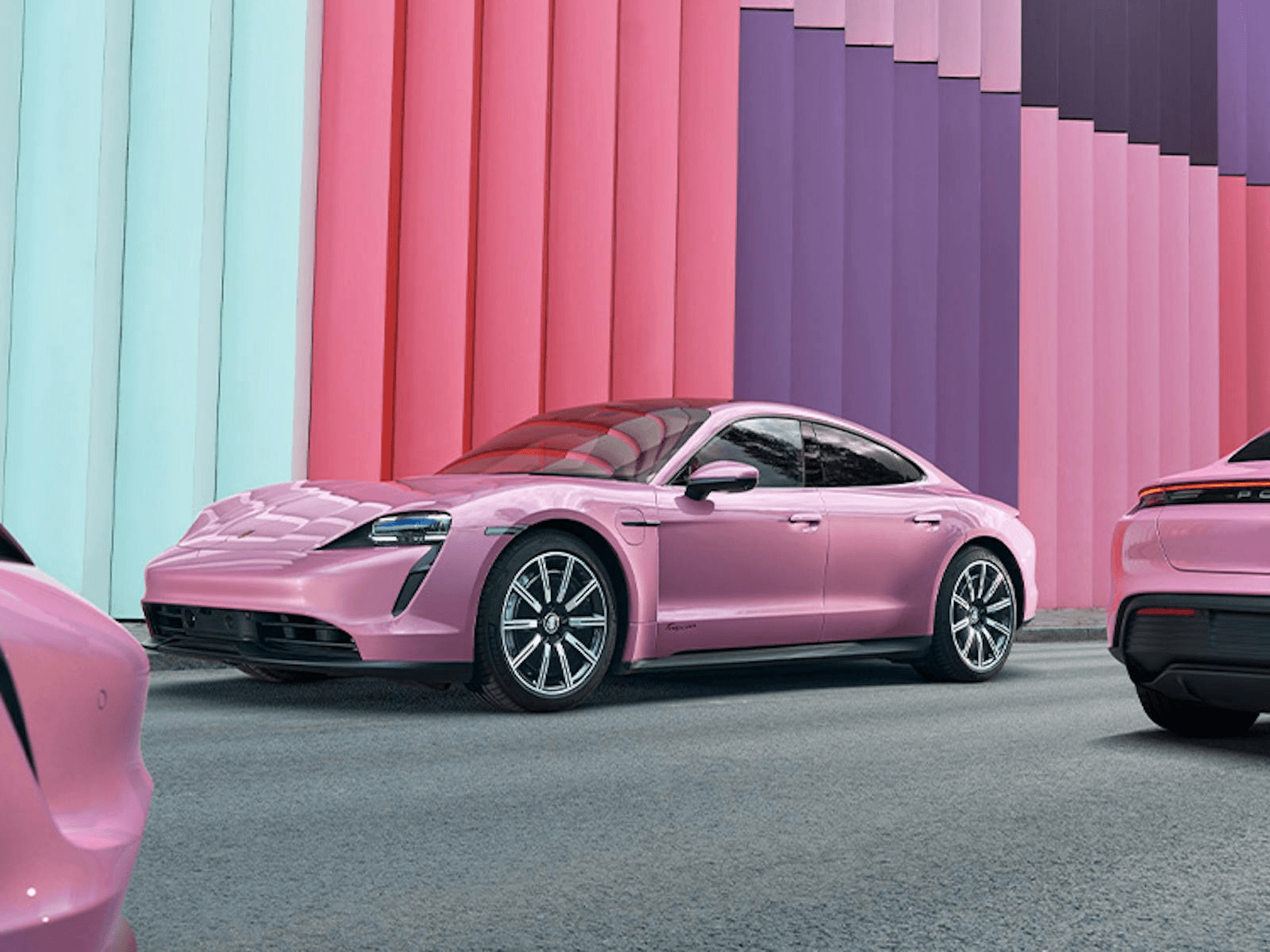 Pink Porsche against a pink, purple and turquoise automotive backdrop
